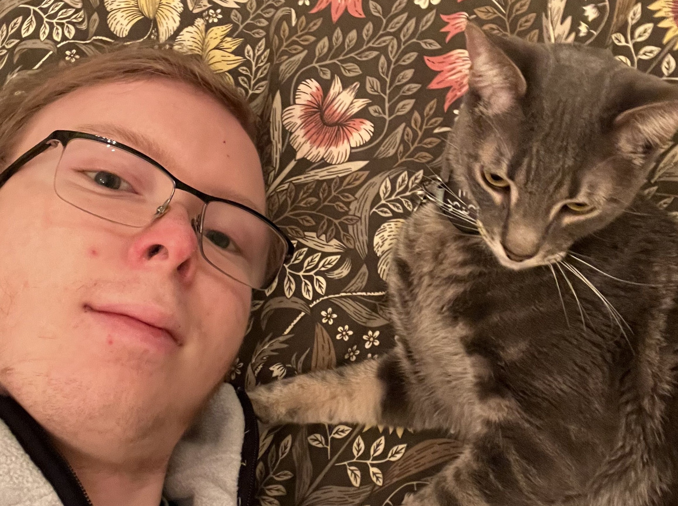 the site owner Cole Krushel sitting next to his cat Maus